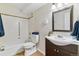 Bathroom featuring a combined shower and tub with a clean white toilet and dark vanity at 585 S Alton Way # 6B, Denver, CO 80247