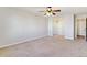 A spacious bedroom with natural light, neutral carpeting, and mirrored closet doors at 585 S Alton Way # 6B, Denver, CO 80247