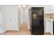 Galley kitchen featuring tile flooring and a refrigerator appliance at 585 S Alton Way # 6B, Denver, CO 80247