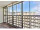 Sunroom with glass block windows overlooking building and mature trees at 585 S Alton Way # 6B, Denver, CO 80247