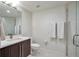 Modern bathroom featuring a single sink vanity, toilet, and glass-enclosed shower with neutral finishes at 4514 W 34Th Ave, Denver, CO 80212