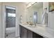 Contemporary bathroom with dual sinks, modern cabinetry, and a sleek shower with tile accents at 4514 W 34Th Ave, Denver, CO 80212