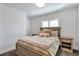 Relaxing bedroom featuring a wooden bed frame, side tables, and natural light from shuttered window at 4514 W 34Th Ave, Denver, CO 80212