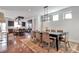 Open dining area showcasing wood floors and an adjacent modern kitchen with stainless appliances at 4514 W 34Th Ave, Denver, CO 80212