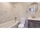 Modern bathroom with marble-tiled bathtub and vanity at 2043 Elmira St, Aurora, CO 80010