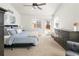 Bedroom featuring a blue bedspread, vaulted ceiling, and backyard views at 4390 E Harvard Ave, Denver, CO 80222