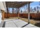 Backyard patio with concrete slab, wooden pergola, and string lights at 4390 E Harvard Ave, Denver, CO 80222