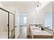 Bathroom with double vanity, granite countertops, black fixtures, and a glass-enclosed shower with bench seating at 1904 Water Birch Way, Castle Rock, CO 80108