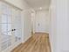 Bright hallway with wood floors, white walls, and a glass-paned door leading to another room at 1904 Water Birch Way, Castle Rock, CO 80108