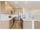 Bright kitchen featuring an island, stainless steel appliances, wood cabinets, and modern finishes at 1904 Water Birch Way, Castle Rock, CO 80108