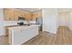 Bright kitchen featuring an island, stainless steel appliances, wood cabinets, and modern finishes at 1904 Water Birch Way, Castle Rock, CO 80108