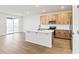 Modern kitchen with a center island, stainless steel appliances, and access to a deck through a sliding door at 1904 Water Birch Way, Castle Rock, CO 80108