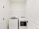 Laundry room featuring white washer and dryer, and a wire shelf above at 1904 Water Birch Way, Castle Rock, CO 80108
