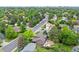 Aerial view of a neighborhood showcasing the home's location, mature trees and the surrounding community at 11035 E Berry Ave, Englewood, CO 80111