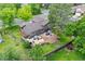 Aerial view of a home featuring a patio, a manicured lawn, and lush landscaping at 11035 E Berry Ave, Englewood, CO 80111