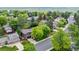 Aerial view of a home with well-maintained landscaping, mature trees, and a peaceful neighborhood setting at 11035 E Berry Ave, Englewood, CO 80111