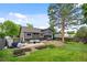 Charming home featuring a large backyard with a patio, comfortable seating, and well-maintained lawn at 11035 E Berry Ave, Englewood, CO 80111