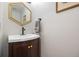 Contemporary powder bathroom with stylish fixtures and hexagonal mirror at 11035 E Berry Ave, Englewood, CO 80111