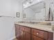 Bathroom featuring a marbled granite countertop, framed mirror, and a sleek sink with modern fixtures at 11035 E Berry Ave, Englewood, CO 80111