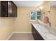 A secondary bathroom has double sinks and modern fixtures at 11035 E Berry Ave, Englewood, CO 80111