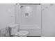 Bathroom featuring a shower/tub combination with white tile, a new toilet, and sleek fixtures at 11035 E Berry Ave, Englewood, CO 80111