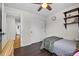 Cozy bedroom featuring hardwood floors, white closet doors, and a view to another room at 11035 E Berry Ave, Englewood, CO 80111