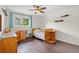 This cozy bedroom features a hardwood floor, desk and shelving at 11035 E Berry Ave, Englewood, CO 80111
