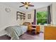 Bedroom featuring a sunny window, shelves and a desk, great for studying or relaxing at 11035 E Berry Ave, Englewood, CO 80111