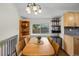 Bright dining area featuring a large window and stylish decor, with an adjacent kitchen area at 11035 E Berry Ave, Englewood, CO 80111