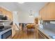 Bright kitchen with stainless steel appliances, granite countertops, an open dining area, and a fireplace at 11035 E Berry Ave, Englewood, CO 80111