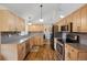 Traditional kitchen featuring stainless steel appliances, granite countertops, and wood cabinetry at 11035 E Berry Ave, Englewood, CO 80111