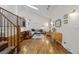 Open living room featuring hardwood floors, staircase, skylight, and comfortable seating area at 11035 E Berry Ave, Englewood, CO 80111