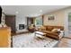 Inviting living room with fireplace, leather furniture, and stylish rug at 11035 E Berry Ave, Englewood, CO 80111