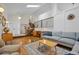 Spacious living room with hardwood floors, staircase, skylight, and comfortable seating area at 11035 E Berry Ave, Englewood, CO 80111