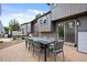 Back patio area featuring a gray dining table and chairs perfect for outdoor entertaining at 11035 E Berry Ave, Englewood, CO 80111