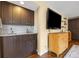 The wet bar has cabinets, counter, and backsplash at 11035 E Berry Ave, Englewood, CO 80111