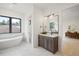 Spa-like bathroom with a freestanding tub and stylish vanity at 1571 Arrowpoint Ct, Franktown, CO 80116