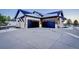 Two-car garage with modern doors and concrete driveway at 1571 Arrowpoint Ct, Franktown, CO 80116