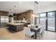 Modern kitchen with large island and stainless steel appliances at 1571 Arrowpoint Ct, Franktown, CO 80116