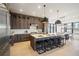 Modern kitchen features dark wood cabinets, marble backsplash and stainless steel appliances at 1571 Arrowpoint Ct, Franktown, CO 80116