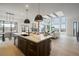 Open concept kitchen with island, white quartz countertops, and stainless steel appliances at 1571 Arrowpoint Ct, Franktown, CO 80116