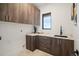 Well-appointed laundry room with ample cabinetry and counter space at 1571 Arrowpoint Ct, Franktown, CO 80116