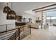 Open living room with hardwood floors and high ceilings at 1571 Arrowpoint Ct, Franktown, CO 80116