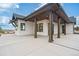 Covered patio with wooden posts and concrete flooring at 1571 Arrowpoint Ct, Franktown, CO 80116