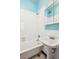 Bathroom with white tiling, shower-tub combo, and updated fixtures at 1351 N Washington St # 23, Denver, CO 80203