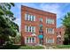 Charming brick apartment building featuring awnings and manicured landscaping at 1351 N Washington St # 23, Denver, CO 80203