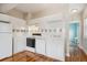 Efficient kitchen with white cabinets, appliances, and tile backsplash at 1351 N Washington St # 23, Denver, CO 80203