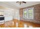 Bright living area with brick accent wall, hardwood floors, and an open layout at 1351 N Washington St # 23, Denver, CO 80203