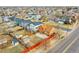 A home in a residential neighborhood featuring a fenced yard, small storage sheds, mature trees, and street access at 14425 E 50Th Ave, Denver, CO 80239
