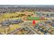 A home set next to a school complex featuring baseball fields, track, and football field, promoting community and activity at 14425 E 50Th Ave, Denver, CO 80239